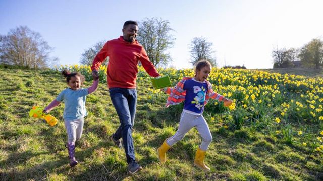 Family running through meadow